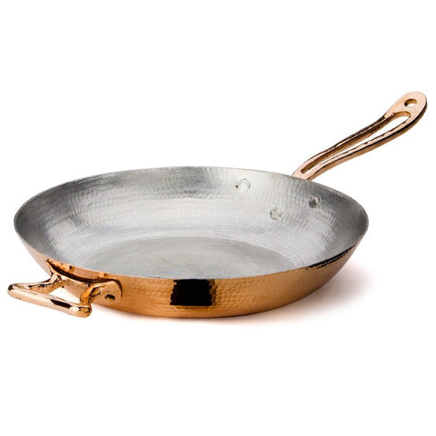 Hand-hammered to perfection by our expert coppersmiths, the 12.5” Fry Pan is a chic cooking staple.  Its gleaming copper exterior is complemented by a double layer of tin interior lining. Applied by hand by our artisans, each layer gives the inside of the pan an even protective coat that guarantees a lasting cookware piece.